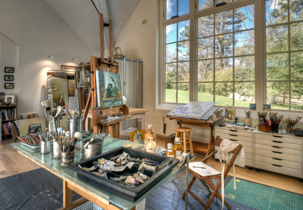 Art-studio-with-a-desk-in-the-center-of-the-room-